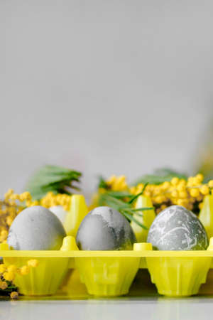 Happy Easter. Marble Eggs Mimosa on the Kitchen Table. Design and traditional decoration for the Holidayの写真素材
