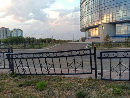 The black fence on the background of the dark sky is askewの写真素材