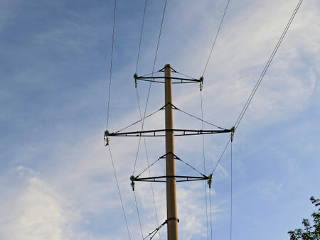 power lines against blue skyの写真素材
