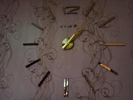 gold clock on the wallの写真素材