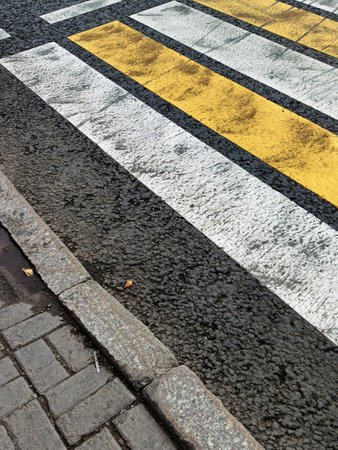 Asphalt road with zebra crossing in the city, closeup of photoの写真素材