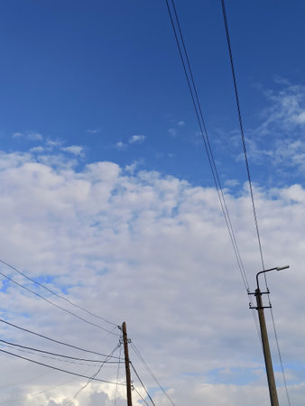 electricity post and blue sky with white clouds in the background.の写真素材