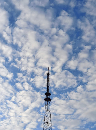 Telecommunication tower with blue sky and white clouds. Sky background.の写真素材