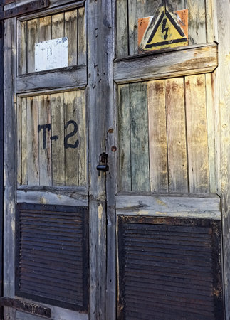Old wooden door with lock and traffic sign on it, closeup of photoの写真素材