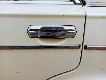 Door handle of a white retro car, closeup of photoの写真素材