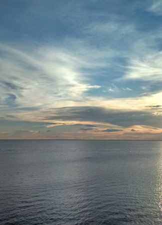 Sunset over the sea with clouds and blue sky. Beautiful natural background.の写真素材