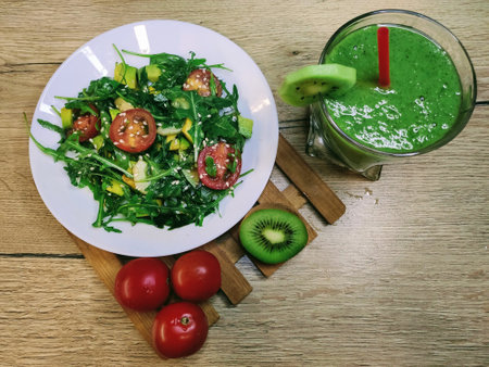 Green smoothie with spinach, kiwi, avocado and cherry tomatoesの写真素材