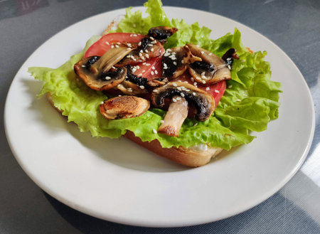 Appetizer with mushrooms, lettuce, tomato and sesame seedsの写真素材