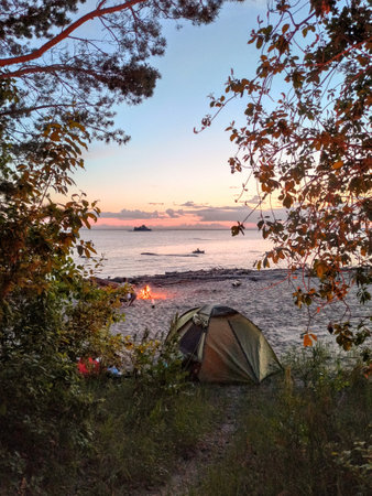 Camping on the beach at sunset. Beautiful landscape in the evening.の写真素材