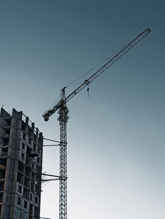 Crane and building under construction with blue sky background, Moscow, Russiaの写真素材