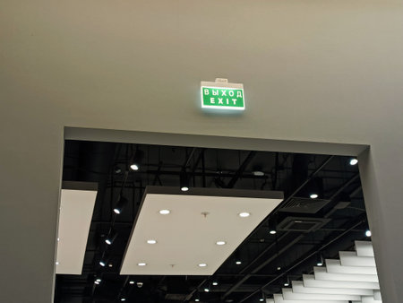Fire exit sign on the ceiling of a modern building in Hong Kong