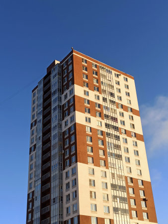 Modern apartment building on a background of blue sky. Facade of a modern apartment building