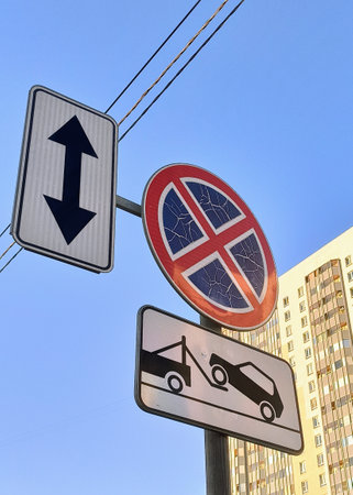 Road signs on a pole against the blue sky, closeup of photoの写真素材
