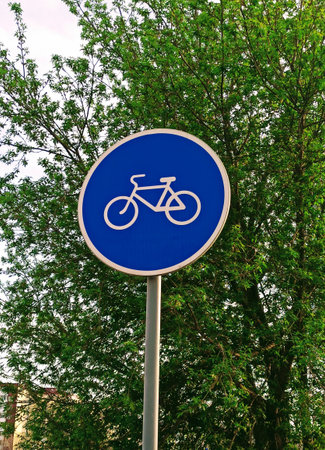 Bicycle road sign on a street in the city. Nature background