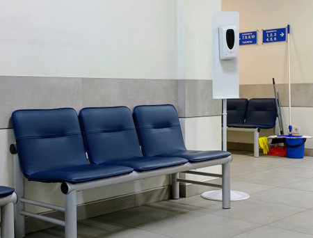 Interior of a waiting room in a hospital, with blue chairsの写真素材
