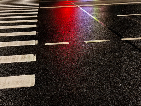 Pedestrian crosswalk in the city at night with red light