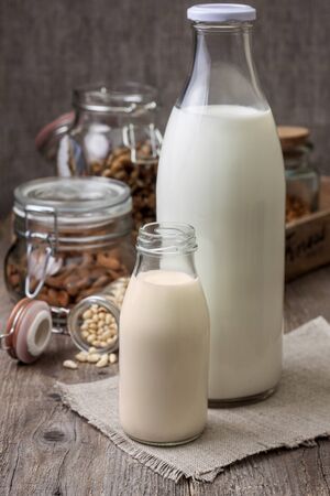 different types of nut milk: almond, cedar, walnut, hazelnut on the old wooden backgroundの写真素材