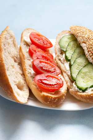 Bun with cottage cheese
, tomato, cucumber on a blue backgroundの写真素材