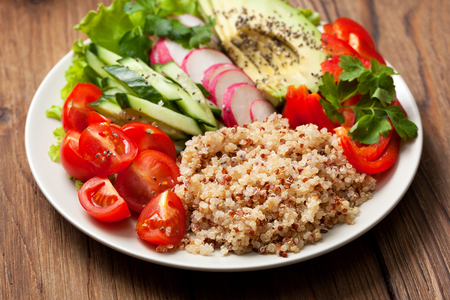 buddha bowl with mixture of vegetables, quinoa  on wooden backgroundの写真素材