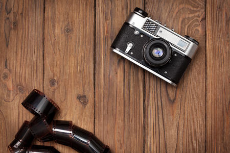 Old camera on an old wooden background. view from above.の写真素材