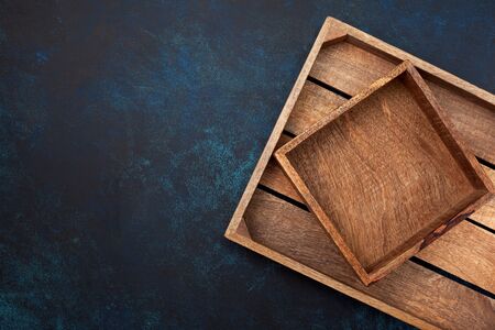 Empty wooden box on blue background. View from above. Copy spaceの写真素材