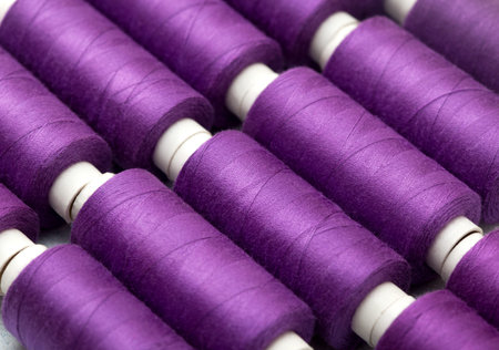 background thread spools purple, violet, lilac close-up