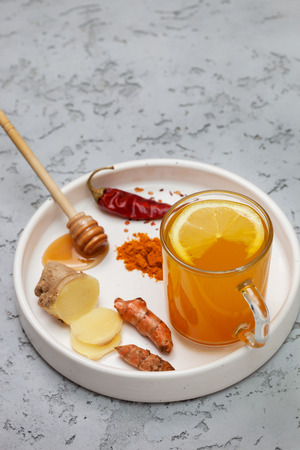 morning detox drink turmeric in the glass on a gray concrete background. copy spaceの写真素材