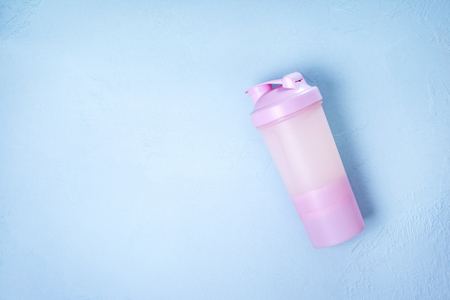 Shaker with protein drink on a blueの写真素材