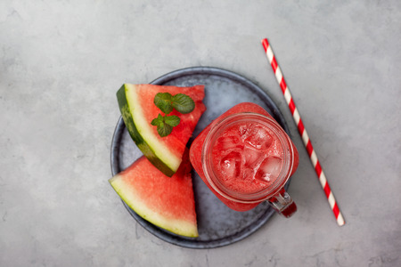 Smoothies watermelon in mason jar on gray concreteの写真素材