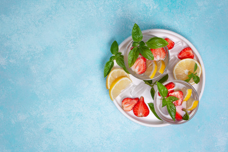 Strawberry basil lemonade in a glass, fresh strawberries, basil on a blueの写真素材