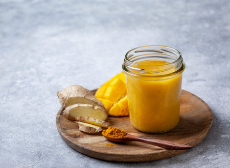 Detox drink. Smoothies with mango, ginger, turmeric in a glass bottle