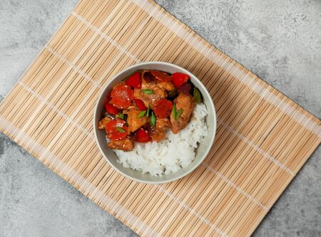 Manchurian chicken with vegetables, rice in a light bowl. view from aboveの写真素材