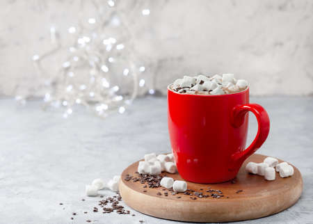 hot chocolate with marshmallows in a red mug on a light backgroundの写真素材
