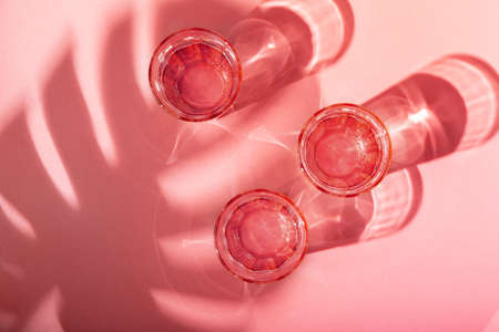 Glasses of water and shadows on the background. Pure minimalist contemporary art. Conceptual image. Simple visual concept.の写真素材