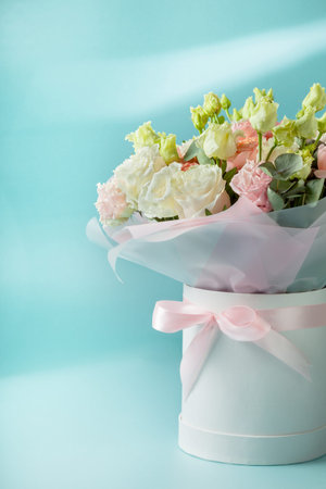 beautiful bouquet of flowers in a hat box. gift for a wedding, birthday, mother's day. copy space