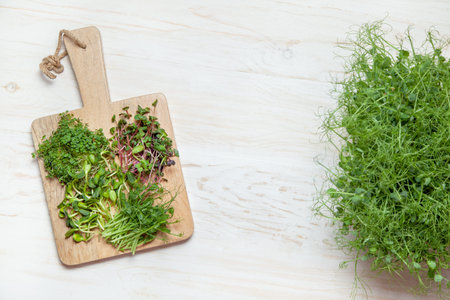 Microgreens growing on the wooden table. top view.