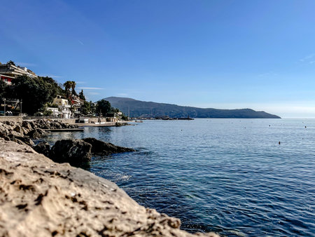 harbor view with sunny terraces, vivid coastal landscape showcasing tranquil town and distant bayの写真素材