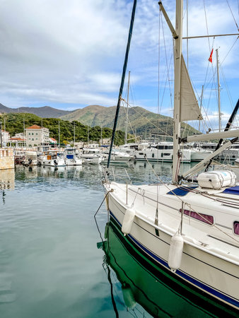 calm waters with vessel nearby, relaxing seaside harbor featuring luxurious yacht and surrounding