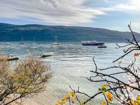 windy sea scene, choppy waters with boats, dramatic sky with gusts and scattered yachting craftsの写真素材