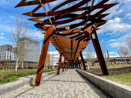 under canopy walkway with rhythmic beams and repeating supports, close-up perspective highlights texture and light play with pedestrian scale, ideal for leisure, tourism and architecturalの写真素材