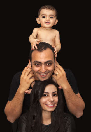 Closeup studio family portrait of a young loving couple with cute baby. High quality photoの写真素材