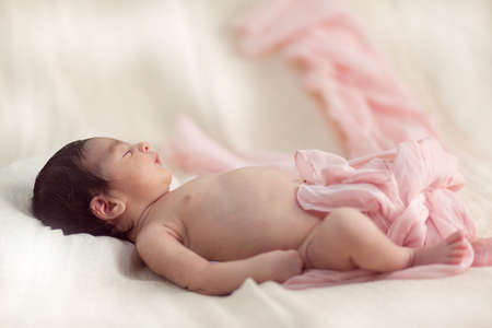 Newborn baby sleeping on the bed. Horisontal oroentation.の写真素材
