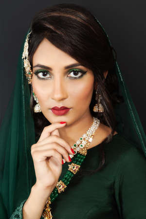 Indian bride in national dress. Studio portrait. Close-up. Bright make-up.Large jewelleryの写真素材