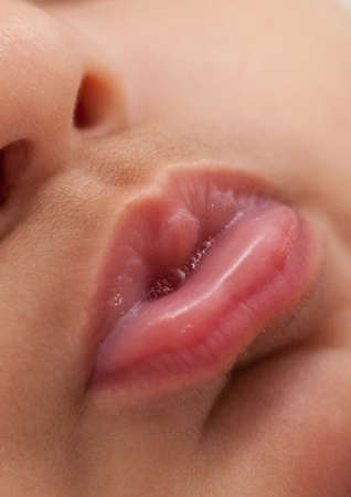 Close-up newborn baby face and lips . High quality photoの写真素材