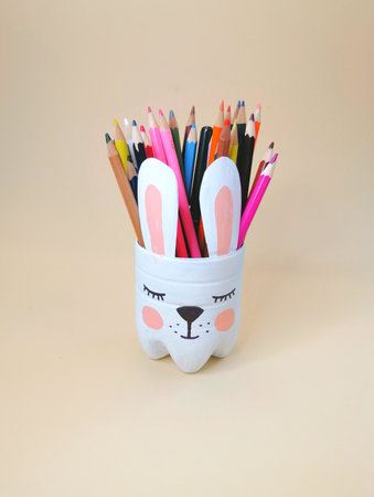 The art of handmade recycling from plastic bottle. Crafts ideas for the childrens room. A container for pencils in the form of a bunnyの写真素材