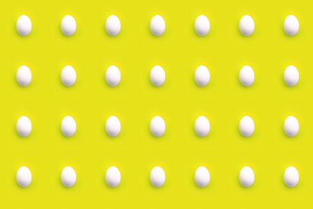 Pattern of white eggs on a yellow backgroundの写真素材