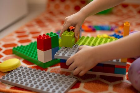 Multi-colored plastic constructor in the hands of the girl. Childrens educational games.の写真素材