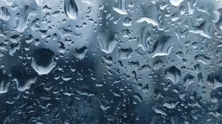 Abstract Background with blue drops on glass of window. Horizontal.の写真素材