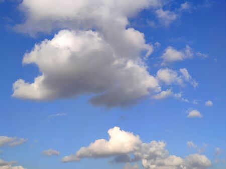 Blue sky with white and gray clouds. Background. Horizontal. Copy spaceの写真素材