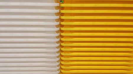 Stack of white and yellow recycled plastic containers in a store. Background. Rhythm.の写真素材